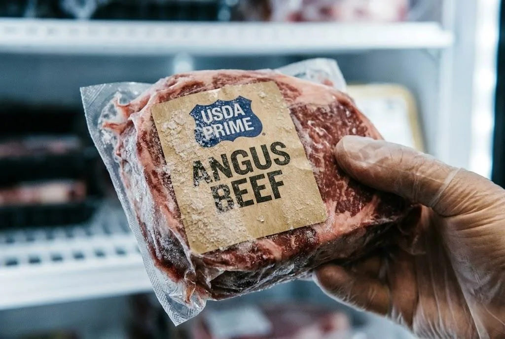 Frozen Angus Beef Package With A Frost Resistant Label In A Freezer, Demonstrating Cold Chain Adhesion.