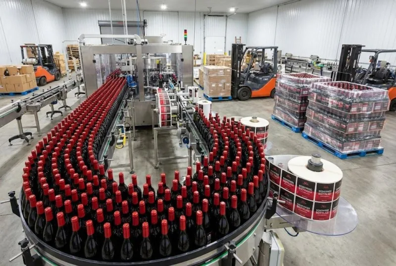 High Volume Automated Wine Bottling Line With Bulk Roll Labels For Industrial Retail Distribution.
