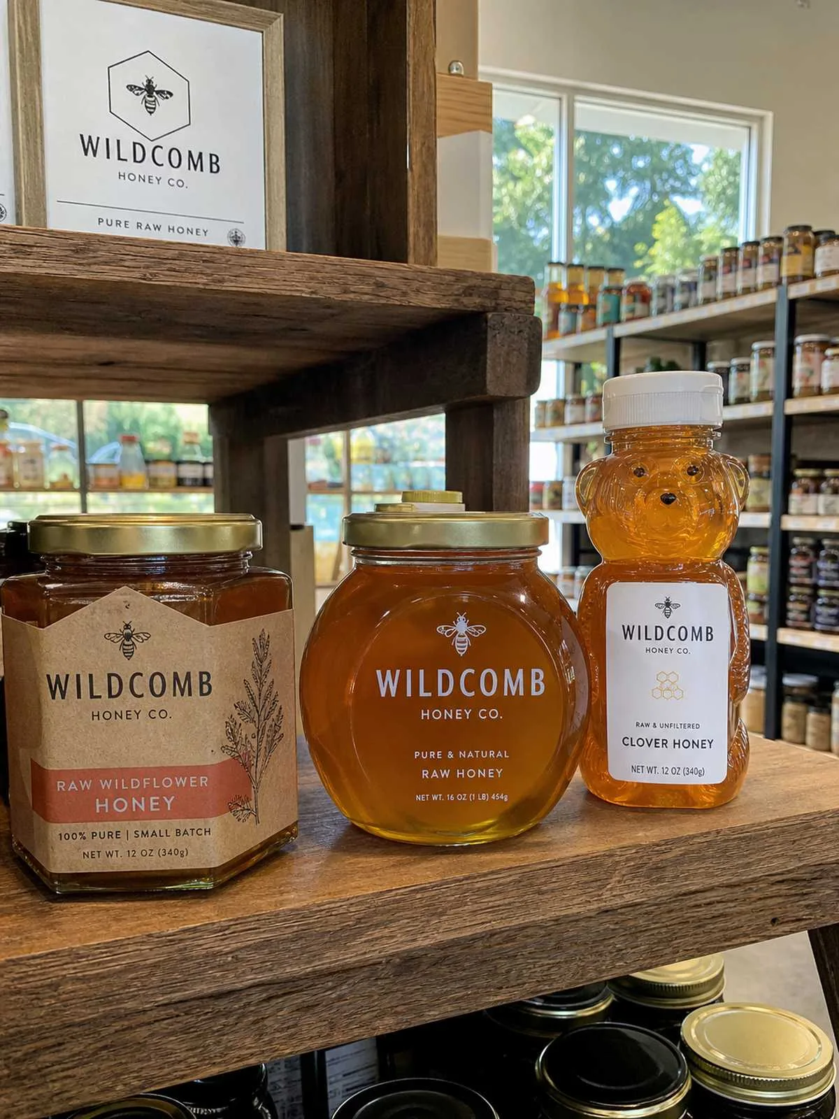 Custom honey labels on artisan glass jars at farmers market