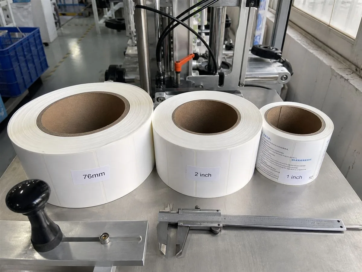 Label roll cores in 76 mm, 2 inch, and 1 inch sizes lined up for applicator matching