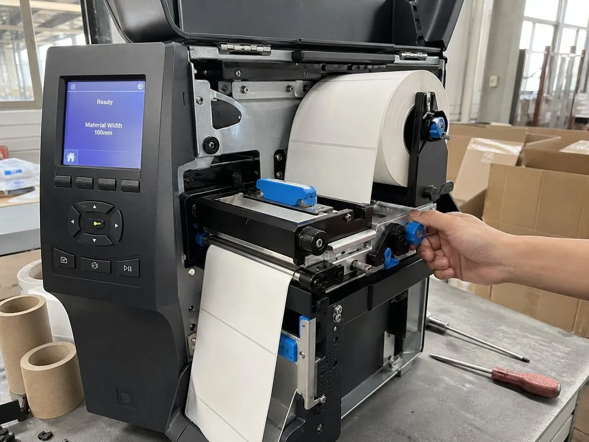 Blank thermal label rolls loaded into an industrial barcode printer