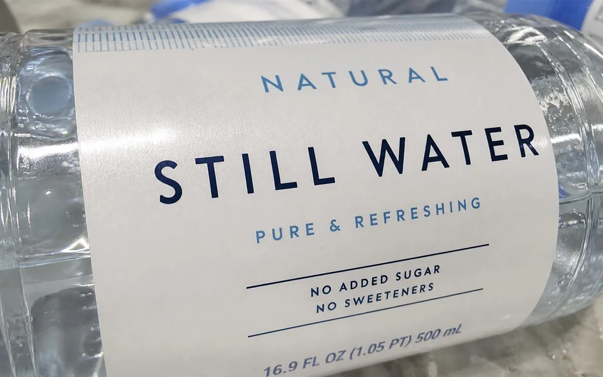 Close-up of label lying flat on curved PET bottle surface without edge lifting