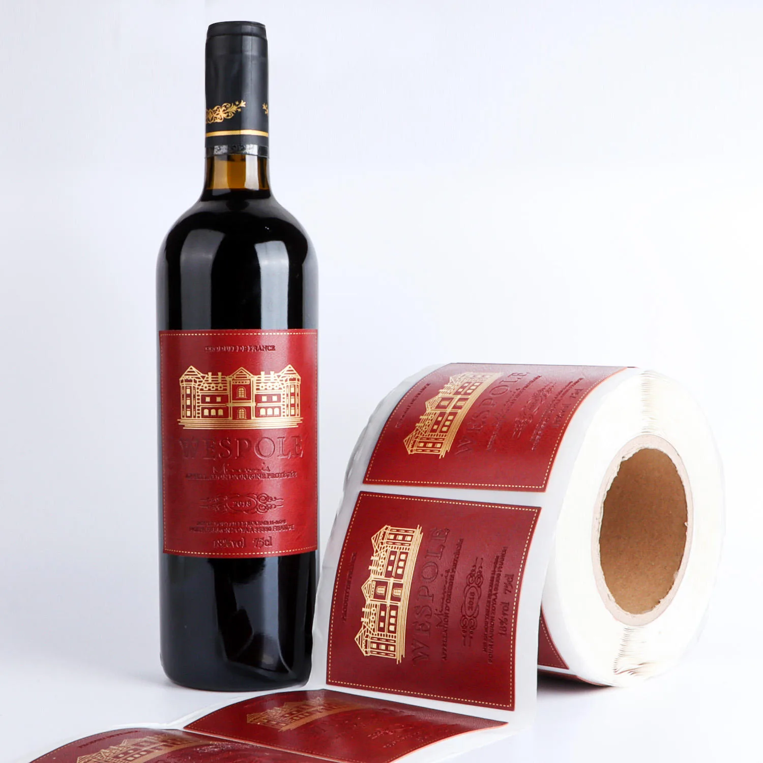 Red Paper Wine Label Roll Beside Bottle