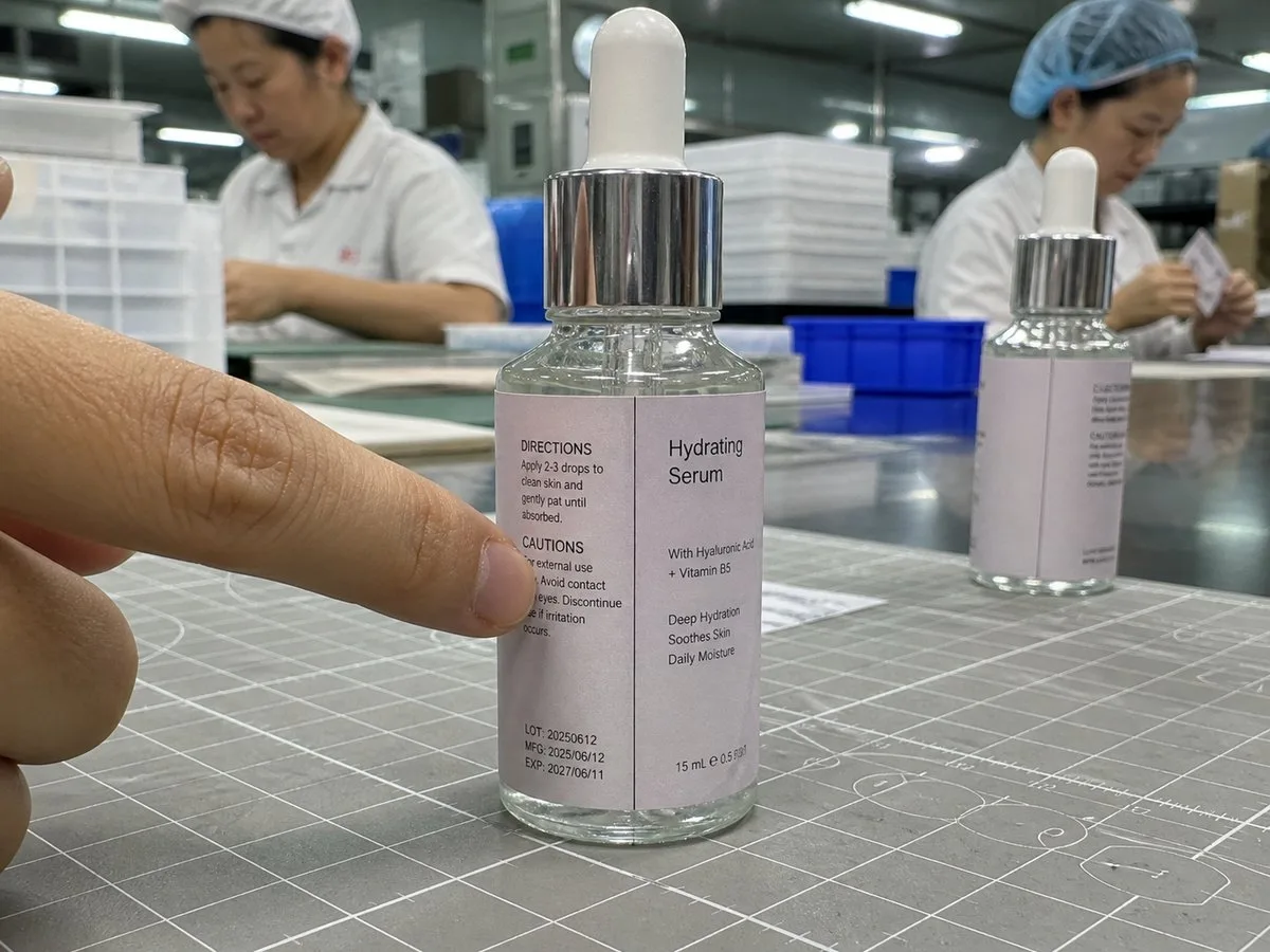Slim dropper bottle with segmented wrap label meeting cleanly
