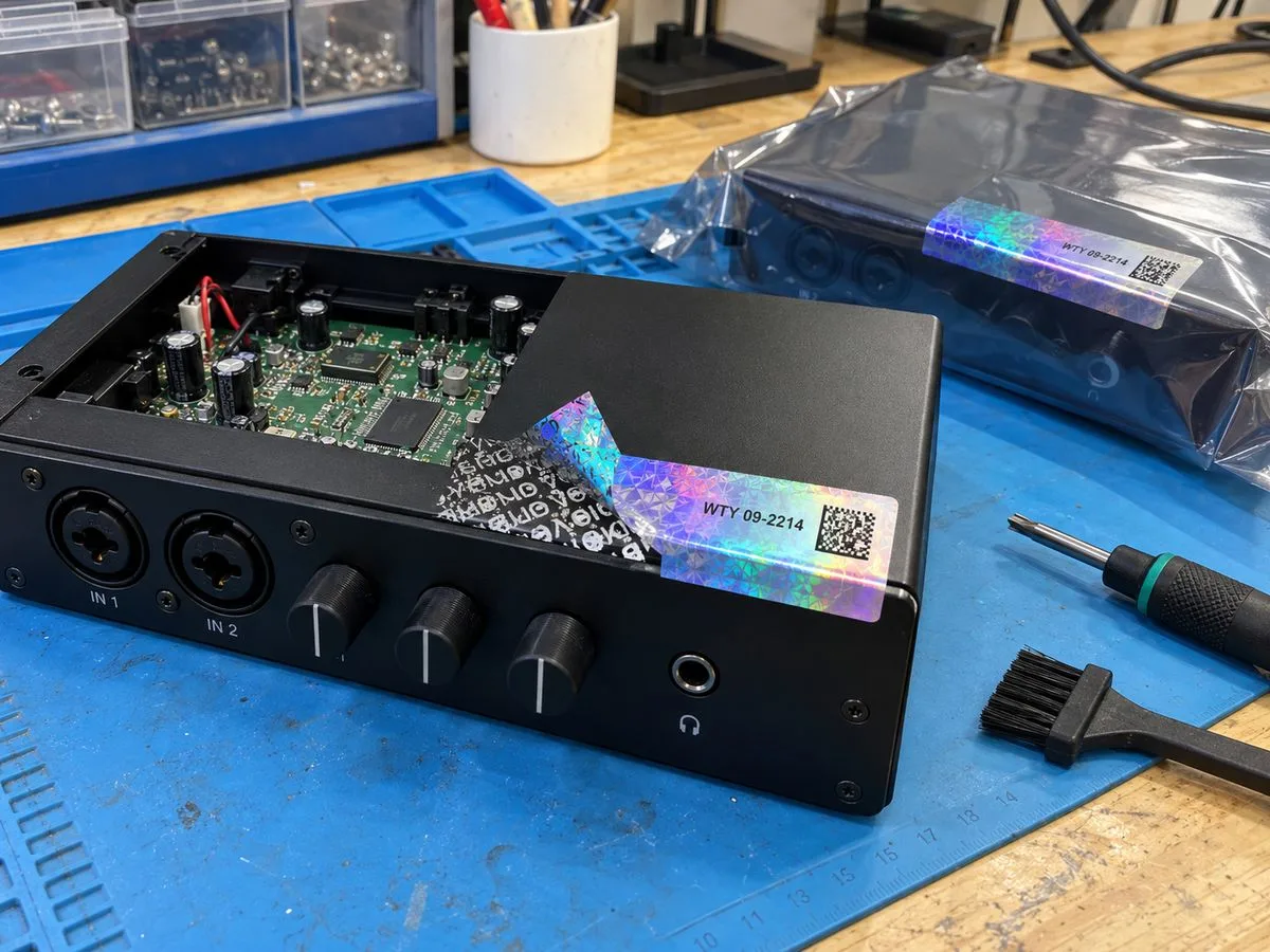 Electronics device with warranty void seal and serial number